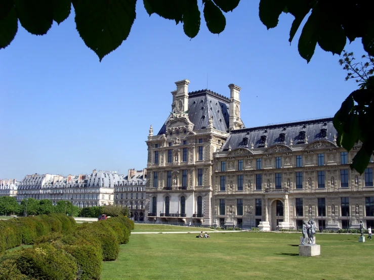 an old building that is surrounded by lush green grass