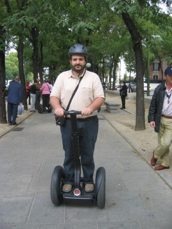 a person with a scooter poses for a picture