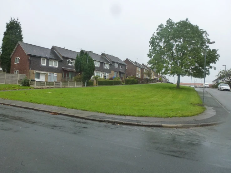 a street corner has green grass on both sides