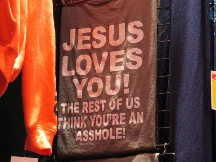 a t - shirt with a message on it hanging from the clothes rack