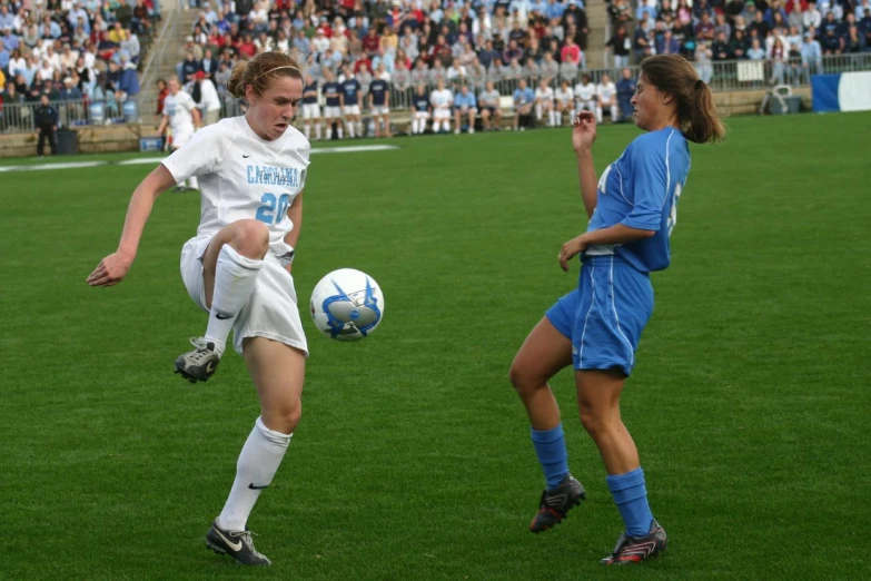 the girl is trying to control the ball while playing soccer