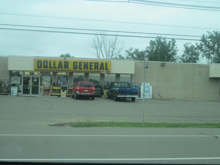 an old dollar general store is empty and the truck shop has two trucks