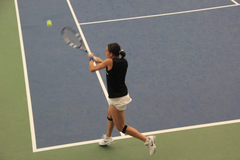 a woman hitting a tennis ball with a racquet