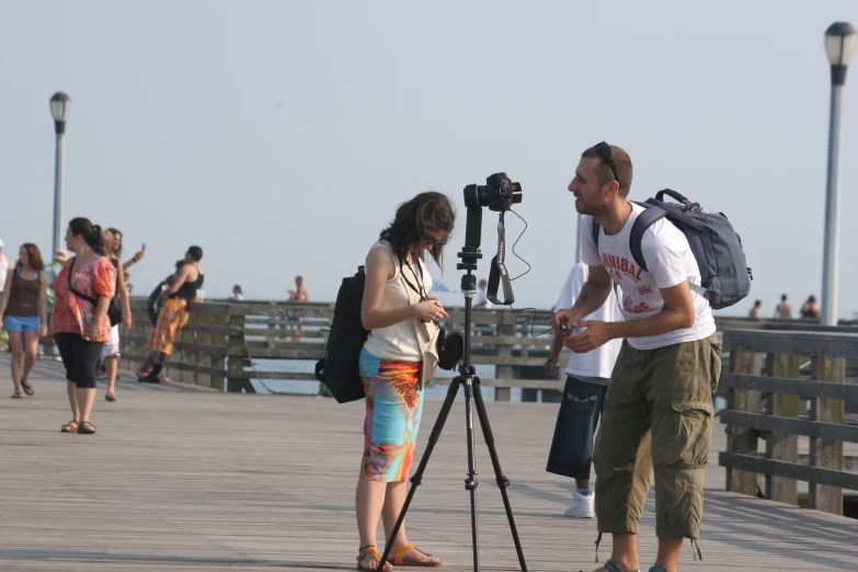 a woman in her pants is taking pos on the pier