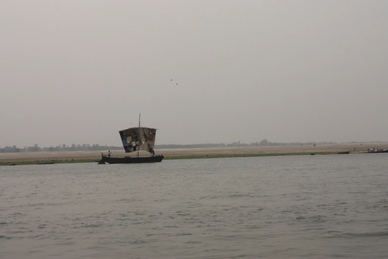 two people are watching a large boat drive out