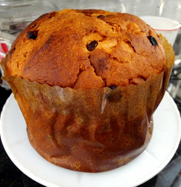 a large muffin sitting on top of a white plate