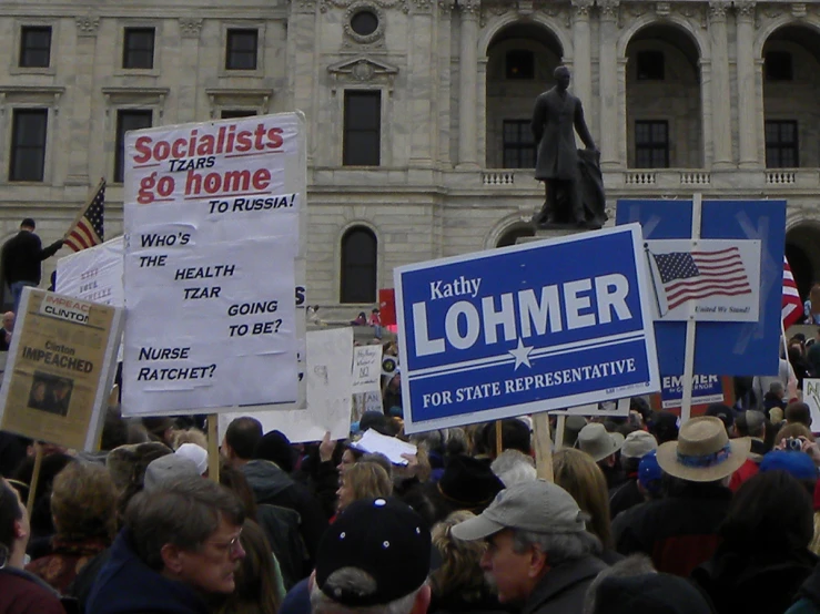 there are many protest signs in front of a building