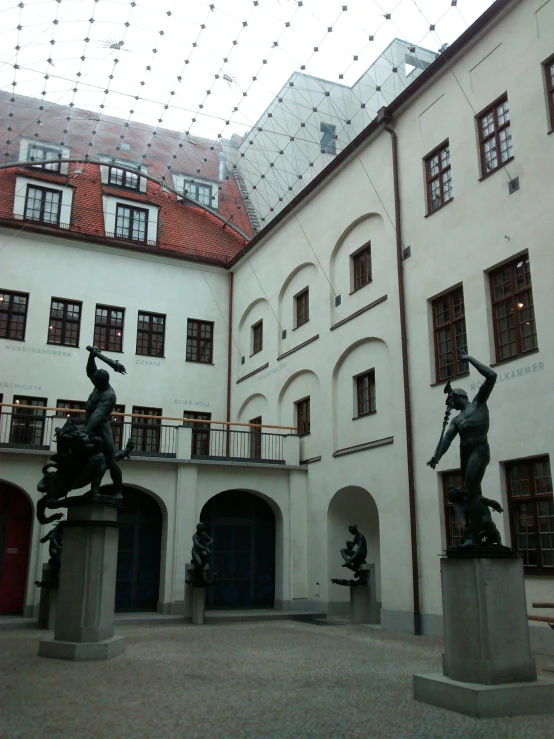 several statues are placed in front of an old building