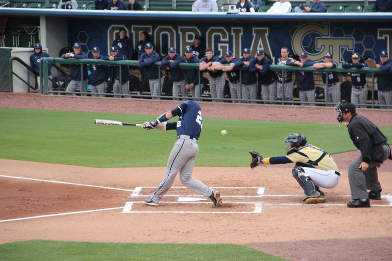 a batter, catcher and umpire playing a baseball game