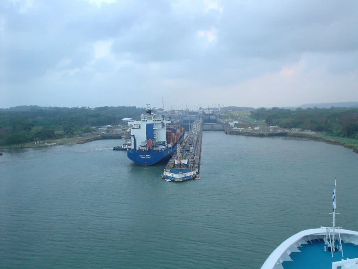 two large ships parked at the docks in the middle of the ocean