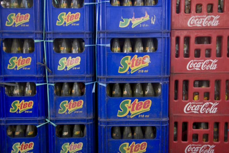 a stack of large, blue and red soda bottles