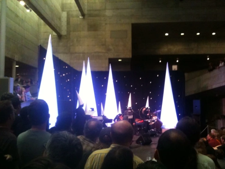 a band performing in a dark room with blue lights on