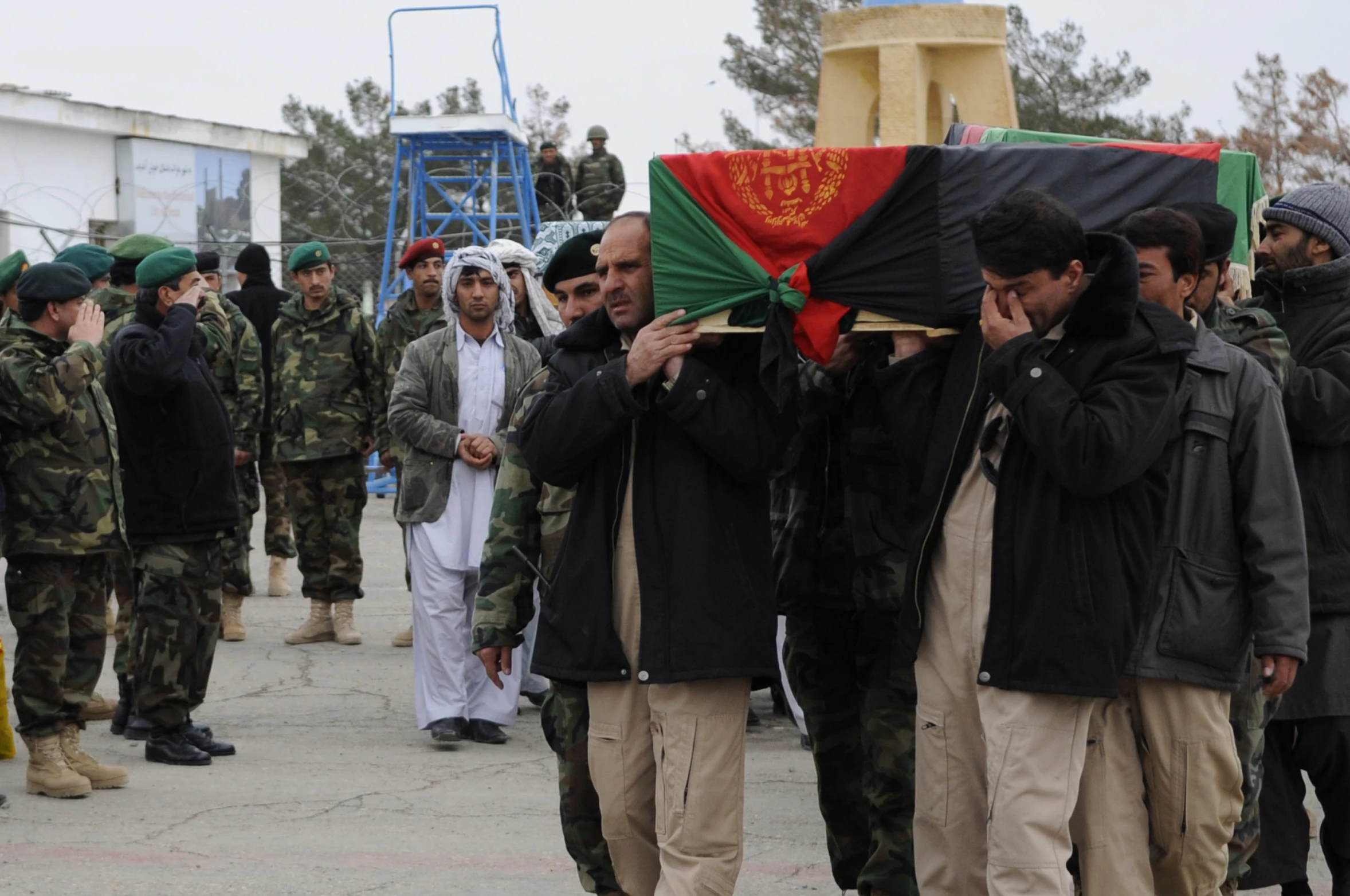 some military men stand and observe soing