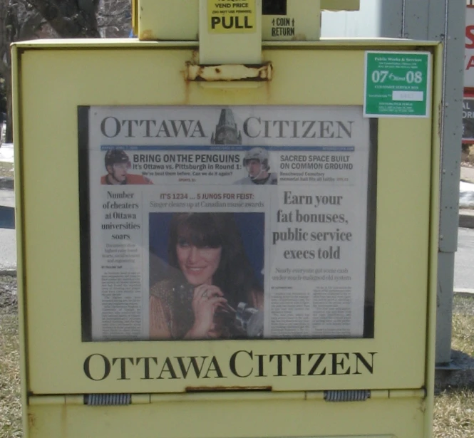 newspaper stand with front page of the ottawa citizen