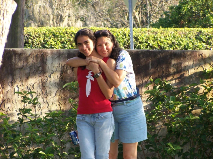 two young women standing next to each other, emcing