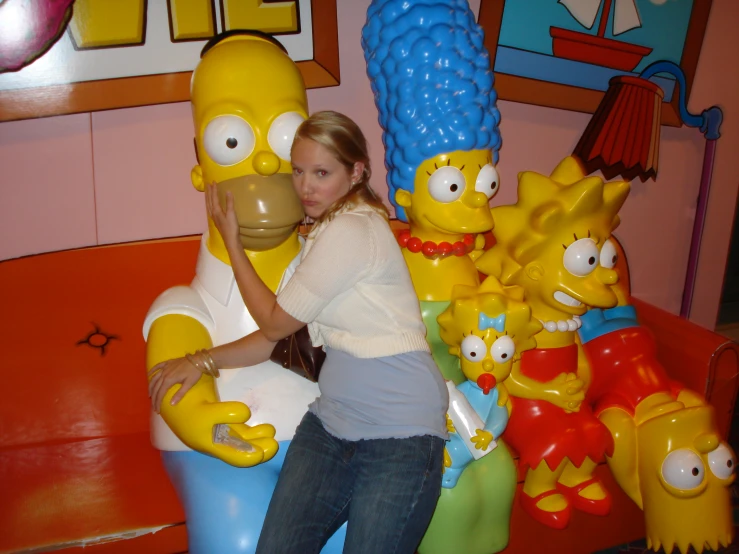 a woman leaning up against some cartoon characters