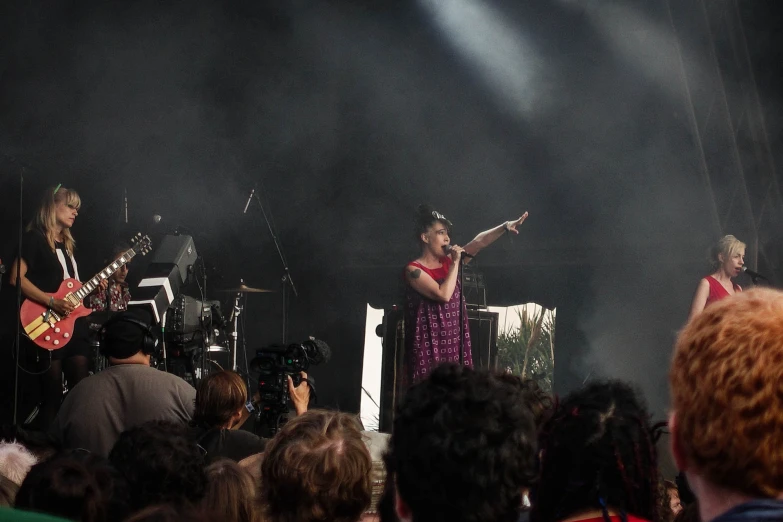 two woman singing on stage in front of an audience