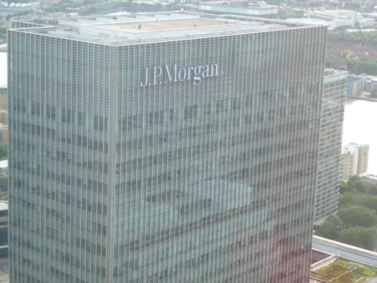 a large gray building with two sky scrs in the air