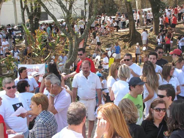 people standing around, one wearing a white shirt