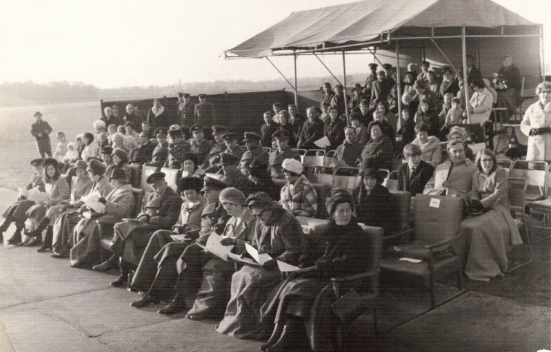 many people in military uniform are standing outside