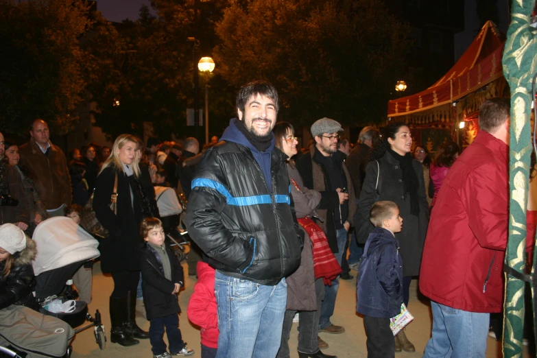 several people standing in line outside at night