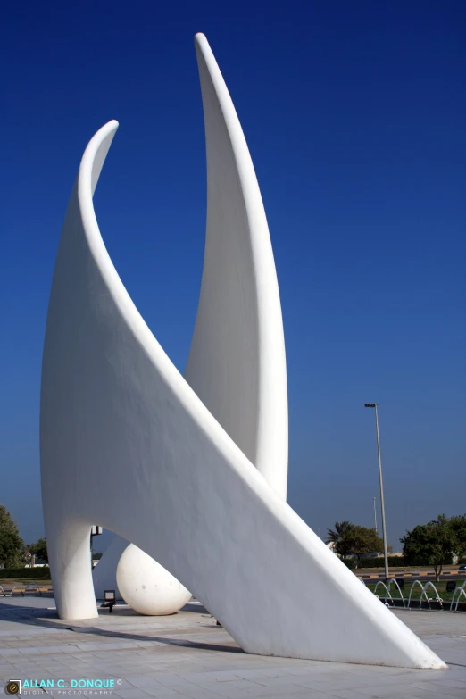 a big white sculpture with a long curved curve