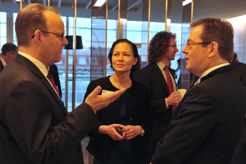 a couple of men and a woman standing next to each other