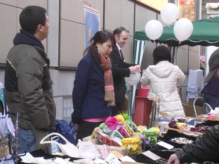 a woman is talking to a man outside