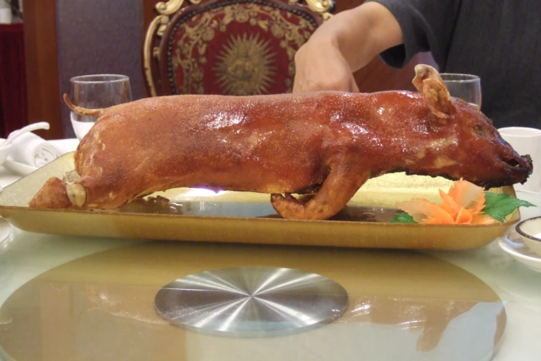 a close up of a plate of food with a person and a pig