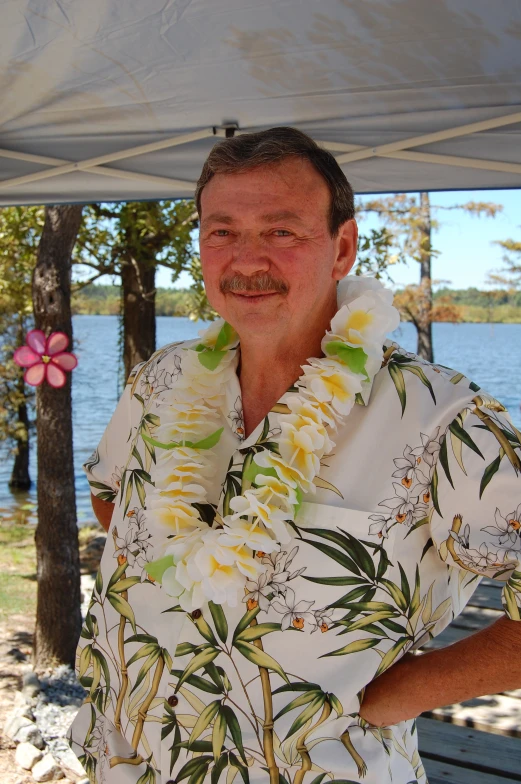 a man standing next to a tree covered in a blanket