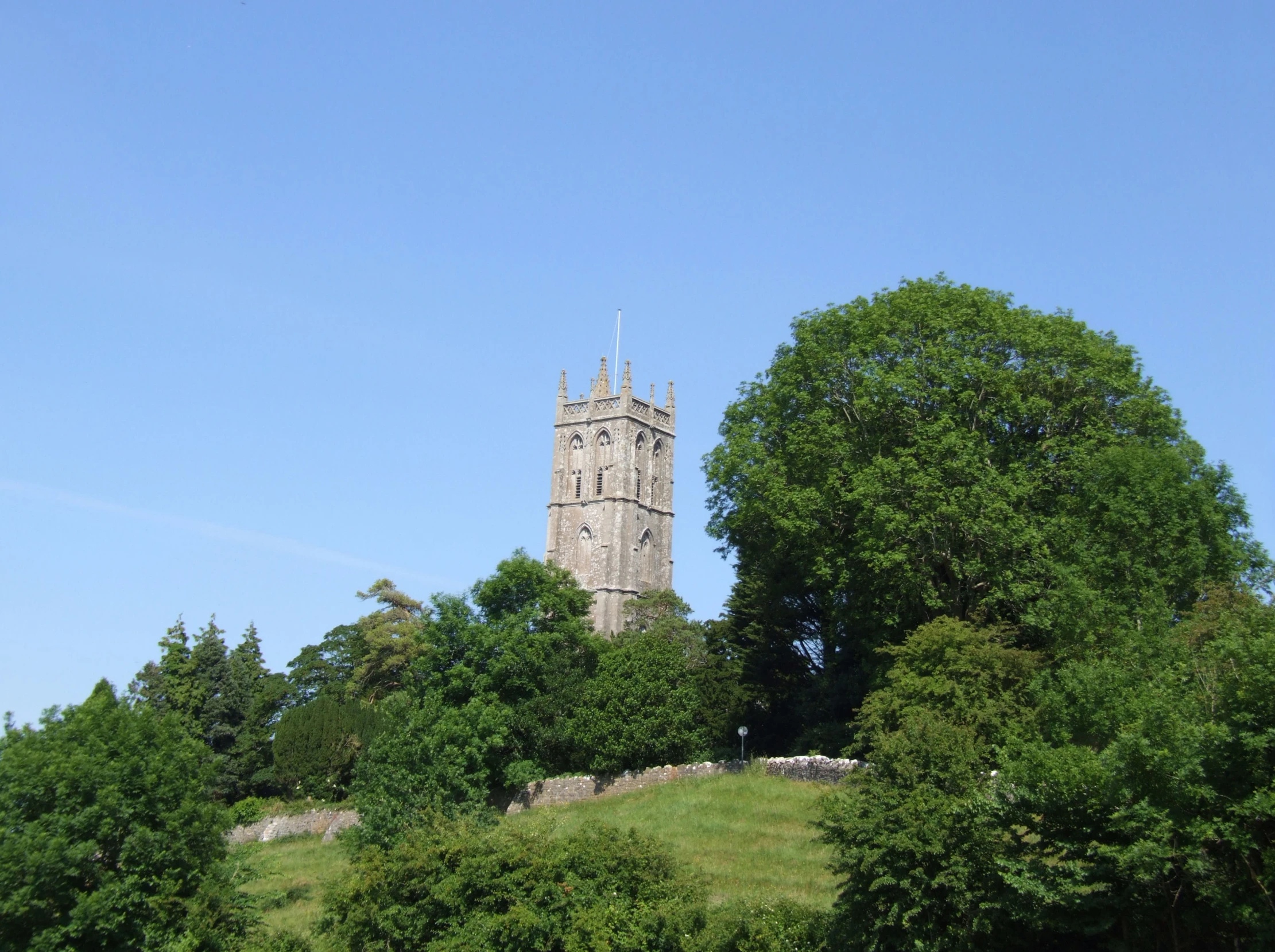 large tower with many spires rising above trees