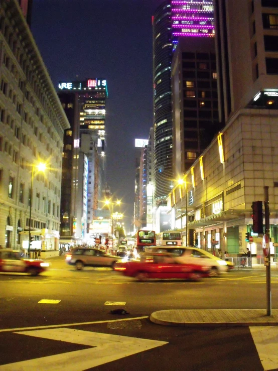 a city street filled with traffic and tall buildings