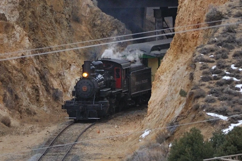 there is a small train going through a tunnel