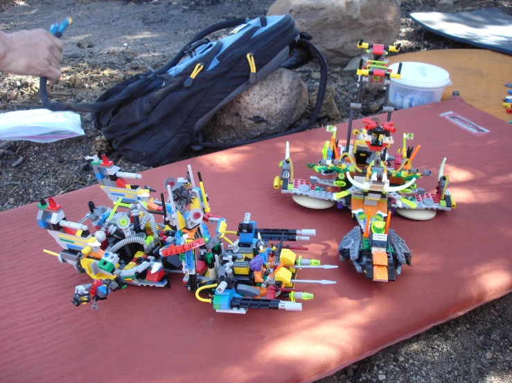 a table covered in toys and equipment, and a bag