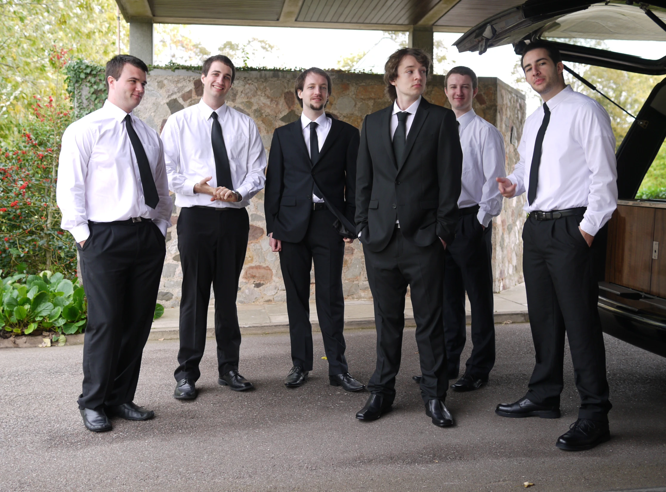 several men dressed in suits are posing for a po