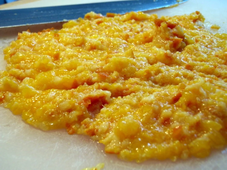 closeup of bread and cheese on a plate next to a  board