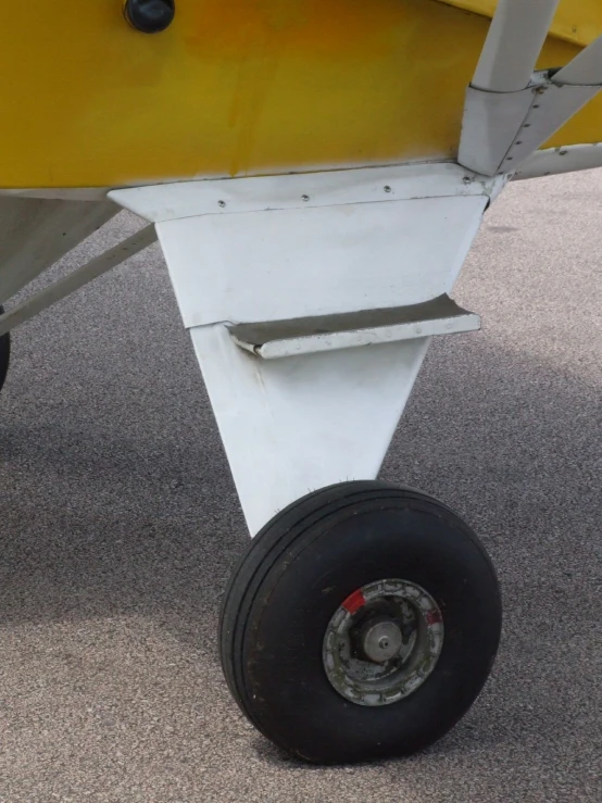 the rear wheels of an airplane as it sits parked