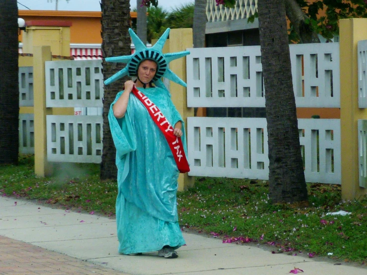 a person that is dressed up in the statue of liberty