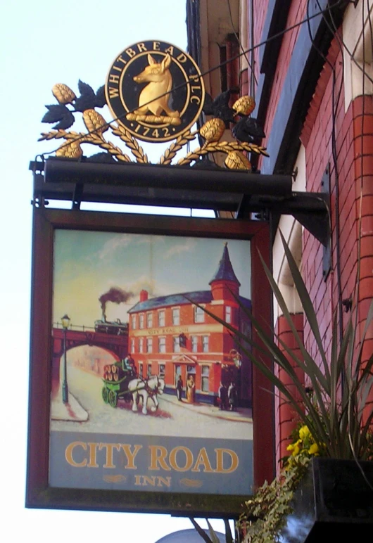 the city road tavern sign is above the building