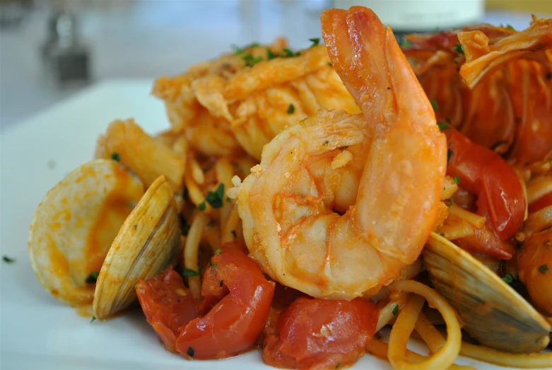 pasta with seafood, tomato sauce and breaded crust on the side