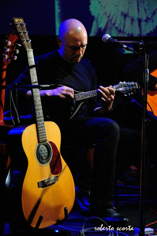 a man playing a song on a guitar