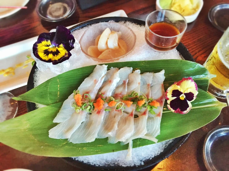 a plate with food on it with two glasses and flower decorations