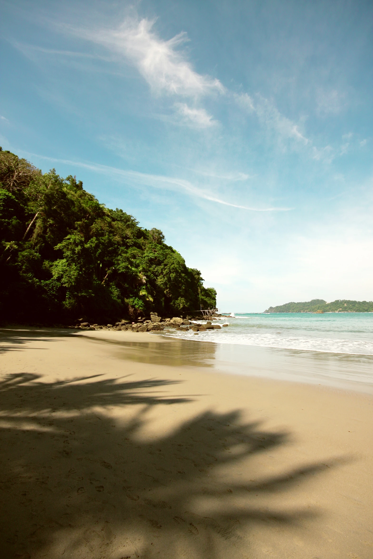 the view is looking down the beach towards the ocean