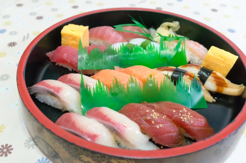 various types of sushi are on display in a round bowl