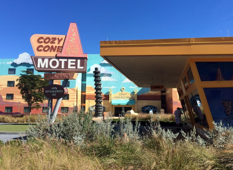 a motel sign in front of a multi colored building