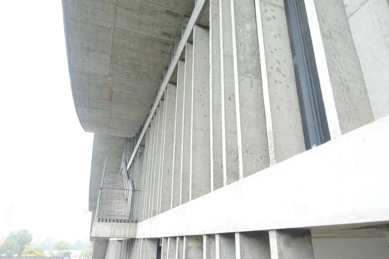 a close up of a stop sign by a concrete structure