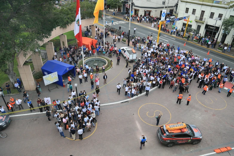 an aerial view of a police station in the middle of town with a police car parked on the road