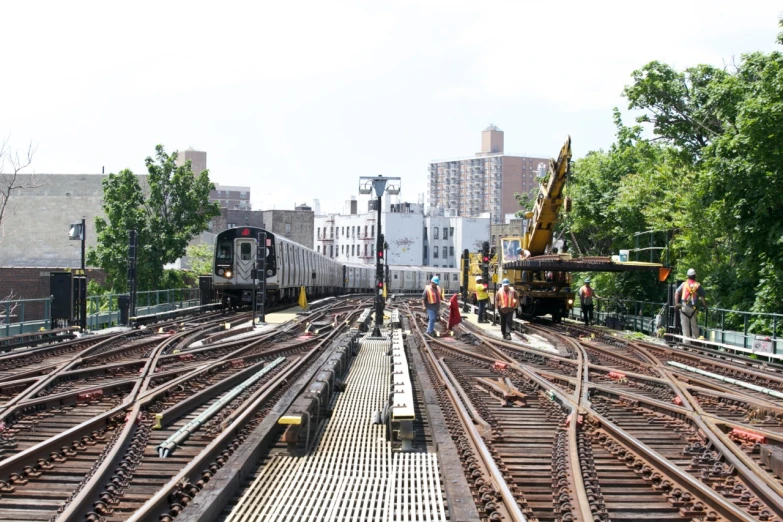 people are standing on the railroad tracks waiting for train