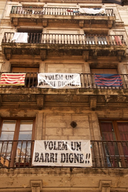 a tall building with a bunch of signs hanging on the outside