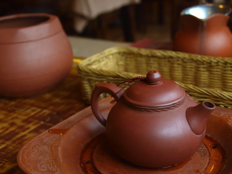 a brown tea pot sitting on top of a plate